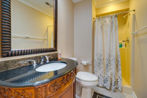 a bathroom with a sink and a toilet and a shower at Condo with 2 Decks - Steps to Wrightsville Beach! in Wrightsville Beach