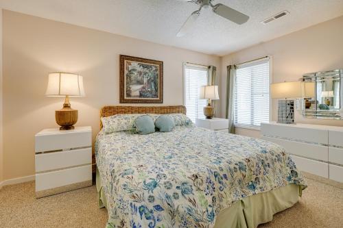 a bedroom with a bed and two lamps and a window at Condo with 2 Decks - Steps to Wrightsville Beach! in Wrightsville Beach