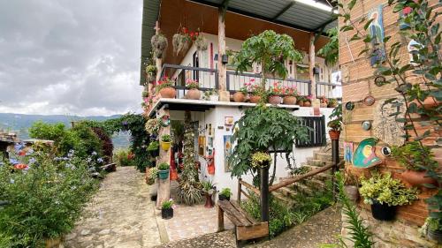 a building with potted plants on the side of it at Finca Renacer in Tibaná