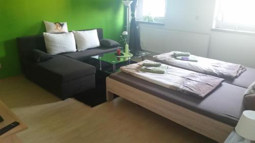 a living room with a couch and a table at Wellness Hotel Pension & Gaststätte Riedel in Kurort Oberwiesenthal