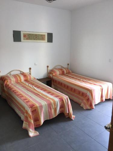 a room with two beds and a sign on the wall at LIOMA VELLA 1 in Peniscola