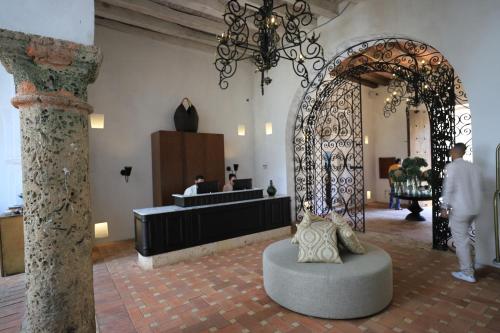 a lobby with a waiting room and a chandelier at Casa Pestagua Relais Châteaux in Cartagena de Indias