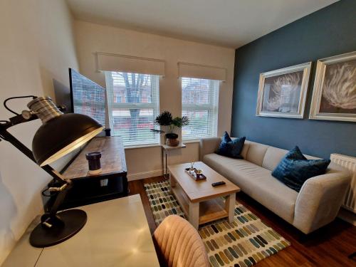 a living room with a couch and a table at Trendy Luxury Serviced Apartment next to City Centre with Free Parking - Contractors & Relocators in Coventry
