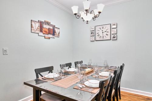 a dining room table with chairs and a clock on the wall at Florida Dream Vacation All new with Amenities in Lutz