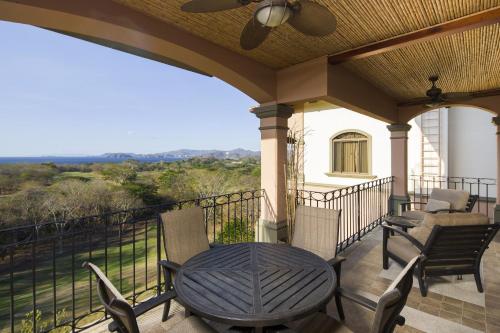 a patio with a table and chairs on a balcony at Jobo 7 Luxury Penthouse - Reserva Conchal in Playa Conchal