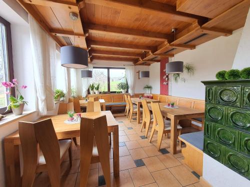 a dining room with wooden tables and chairs at Landhaus Oberaurach in Oberaurach