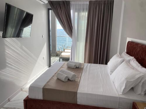 a bedroom with a bed with two towels on it at Candi Luxury Suites in Neos Marmaras