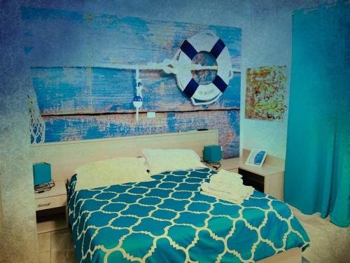 a bedroom with a bed and a blue wall at Residence R&B Tyrrhenum in Monte di Procida