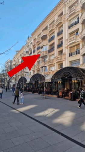 a red arrow on a street in front of a building at Skopje Plaza Apartment in Skopje
