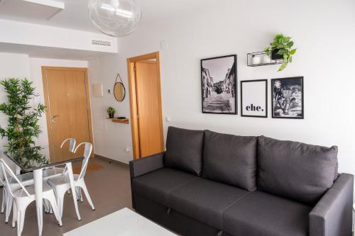 a living room with a couch and a table at Apartamentos Vernia in Xàtiva