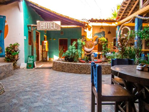 a restaurant with a table and chairs in a courtyard at Hotel Restaurante Spa La Barca de Oro in Las Peñitas