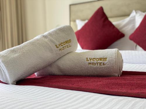 a pair of socks on a bed in a hotel room at "Hotel The Lycoris" Near Bus Stand ZIRAKPUR on AMBALA HIGHWAY in Zirakpur