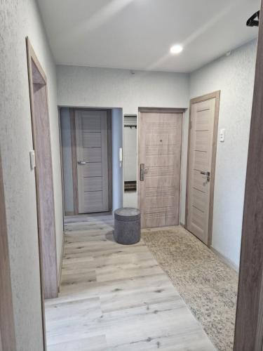 an empty hallway with two doors and a stool at MilaAna in Visaginas