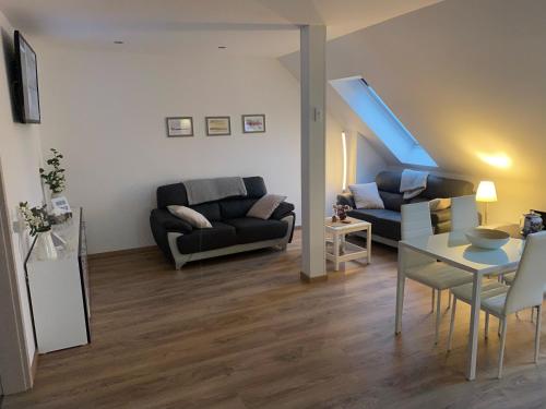 a living room with a couch and a table at FEWO Salzwedel, Zum Dorfplatz in Salzwedel