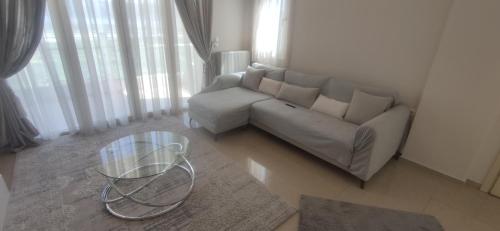 a living room with a couch and a glass table at Η πέρλα της λίμνης/ The lake's pearl in Ioannina