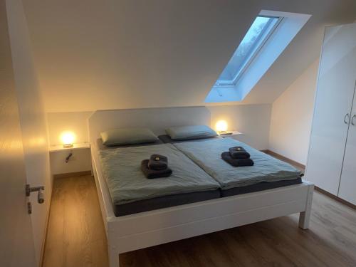a bedroom with a bed with two stuffed animals on it at FEWO Salzwedel, Zum Dorfplatz in Salzwedel
