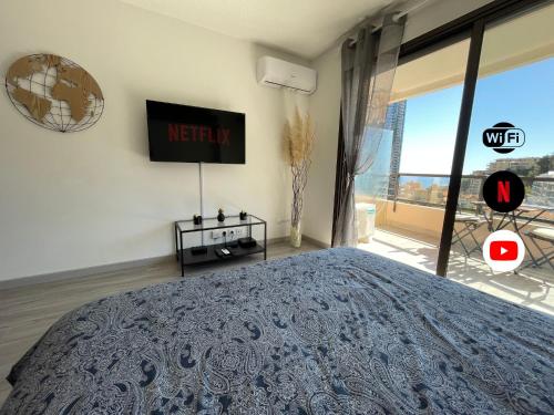 a bedroom with a large bed and a large window at NEW Studio, piscine et vue mer • proche de Monaco in Beausoleil