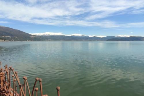 a view of a large body of water with mountains at Η πέρλα της λίμνης/ The lake's pearl in Ioannina