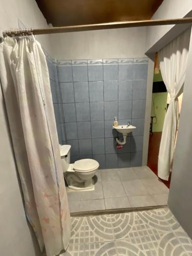 a bathroom with a toilet and a sink at Hostal Familiar in Granada