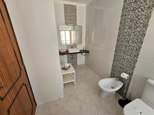a white bathroom with a toilet and a sink at Villa Vista Mar - Galé - Albufeira in Guia
