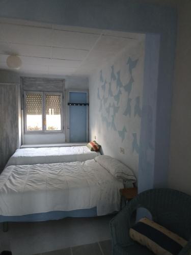 a bedroom with a large bed and a window at Can ventura in Deltebre