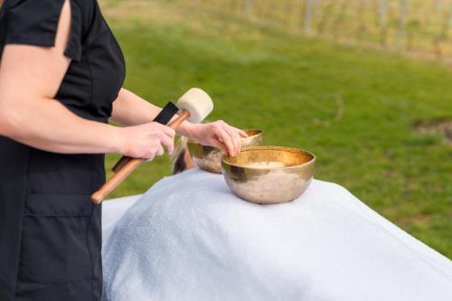 a person is stirring a pot on a table at Château de La Mar Chambres d'Hôtes in Jongieux
