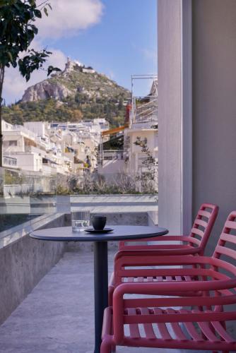 a table and chairs with a view of a mountain at The Social Athens Hotel, a member of Radisson Individuals in Athens