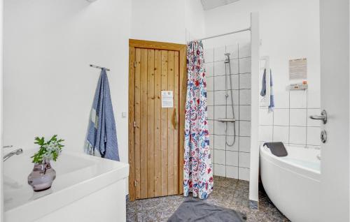 een badkamer met een douche en een houten deur bij Nice Home In Sjlund With Kitchen in Hejls