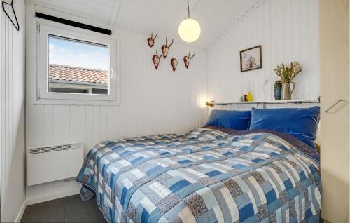 a bedroom with a bed and a window at Awesome Home In Sjlund With 4 Bedrooms, Sauna And Wifi in Hejls