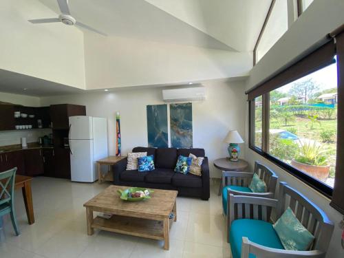 a living room with a couch and a table at Villas Eco Venture in Playa Junquillal