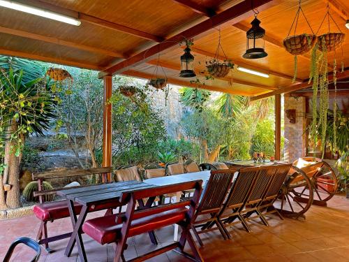 a patio with a table and chairs on a patio at Exquisite rural house with garden, pool and sea views in Arico Viejo