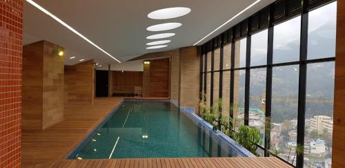 a large swimming pool in a building with windows at Enjoy In Bogotá in Bogotá