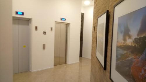 a hallway with two doors and a painting on the wall at Enjoy In Bogotá in Bogotá