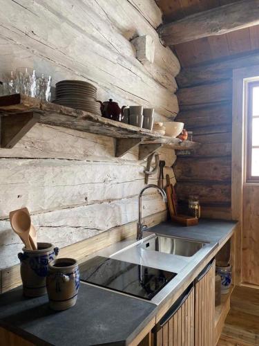 a kitchen with a sink and a counter top at Sauefjøset - Idyllisk gardstun fra 1800-tallet in Skjåk