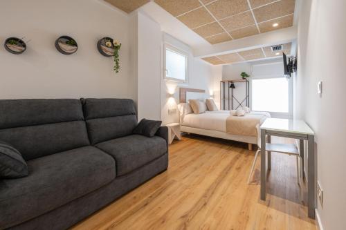 a living room with a couch and a bed at Elegant Rooms Lasarte in Lasarte
