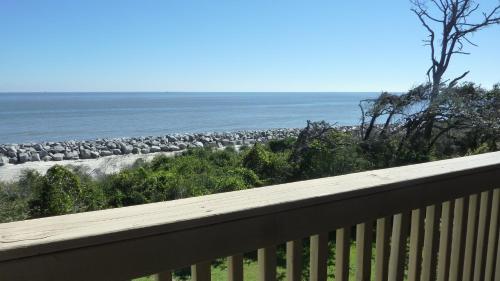 a balcony with a flock of sheep on the beach at Villas by The Sea Three Bedroom Apartment in Jekyll Island
