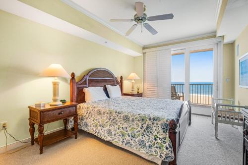 a bedroom with a bed and a balcony with the ocean at Adagio 402 in Ocean City