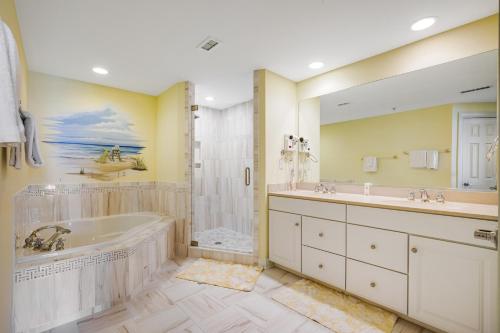 a bathroom with a tub and a sink and a shower at Adagio 402 in Ocean City