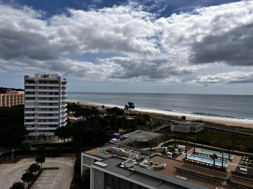 a view of the beach and the ocean from a building at Seaview, beach front, studio in Alvor
