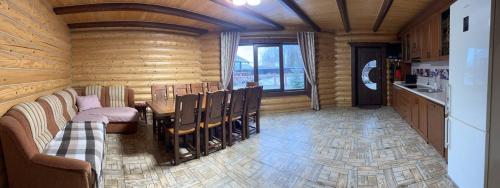 a room with a table and chairs and a kitchen at На ставку in Vyzhnytsya