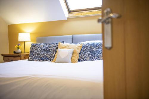 a bedroom with a bed with pillows and a window at Middehus in Redmire