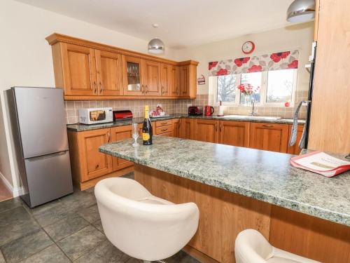 a kitchen with wooden cabinets and a granite counter top at Middlegate in Ryton