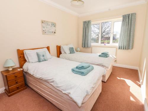 a bedroom with two beds and a window at Middlegate in Ryton