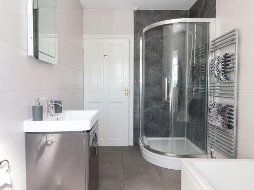 a white bathroom with a shower and a sink at Middlegate in Ryton