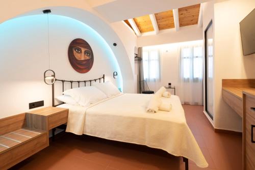 a bedroom with a large bed with a painting on the wall at Sartori Concept Hotel in Heraklio Town
