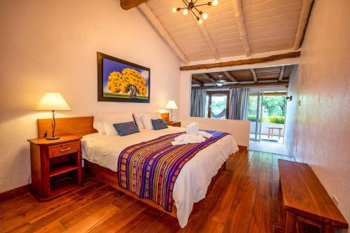 a bedroom with a large bed and a window at Enchanted Galapagos Lodge in Puerto Ayora