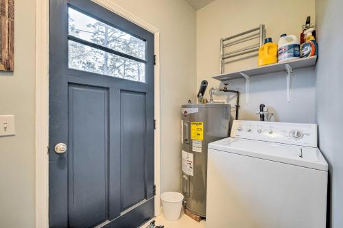 a laundry room with a blue door and a washer at Cozy Wilmington Vacation Rental 10 Mi to Beach! in Wilmington
