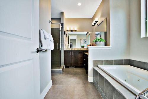 a bathroom with a tub and a sink and a mirror at Entrada at Moab 424 and 428 in Moab