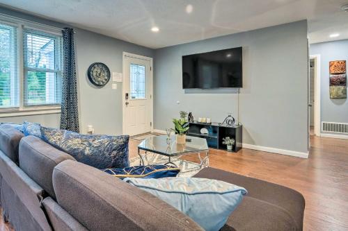 a living room with a couch and a table at Day Trip to D C! Spacious Fort Washington Home in Fort Washington