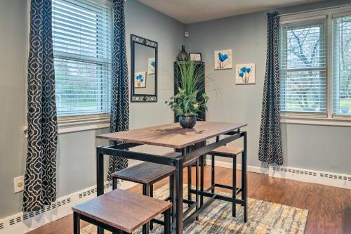 a dining room with a table and chairs and windows at Day Trip to D C! Spacious Fort Washington Home in Fort Washington